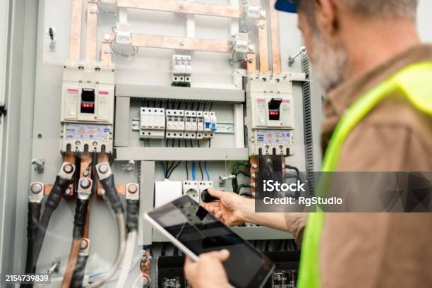 Experienced engineer inspecting the work of the solar panel system.